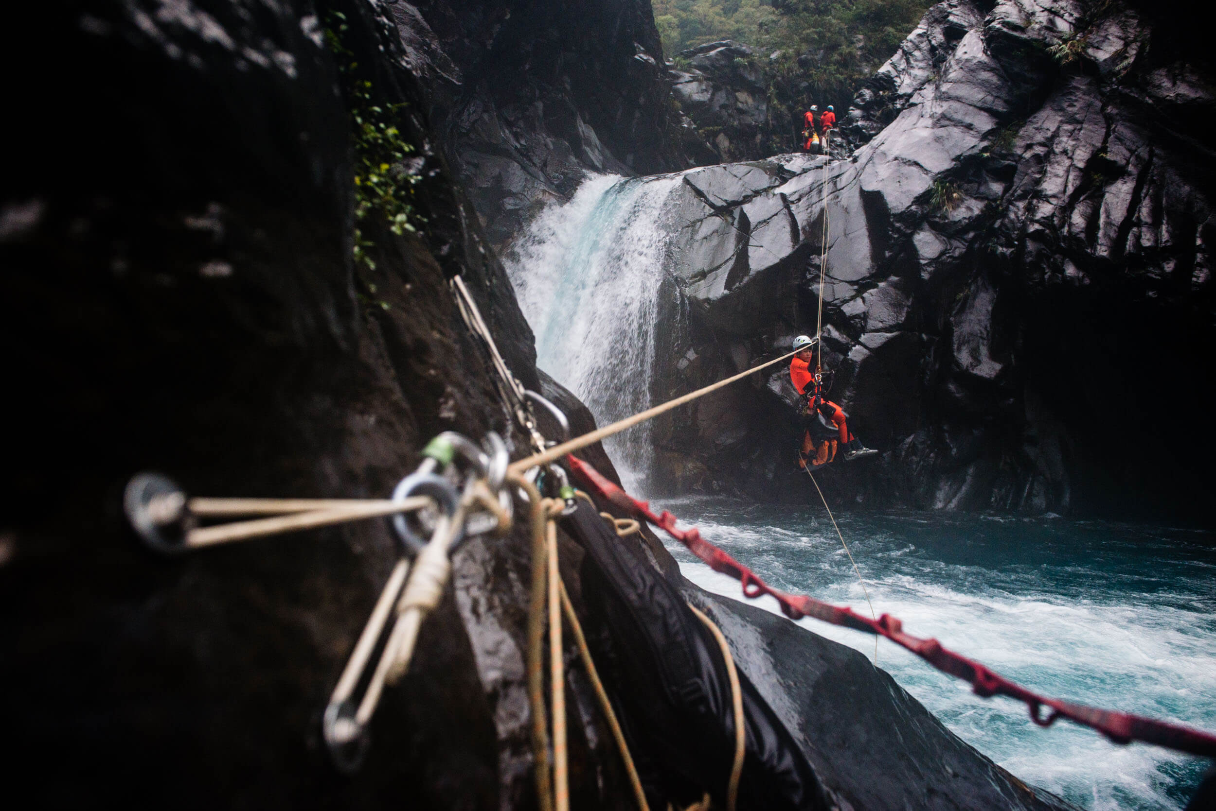 Jasmine Li makes use of a guided rappel to narrowly escape the dangerous crux pool of Malishan.