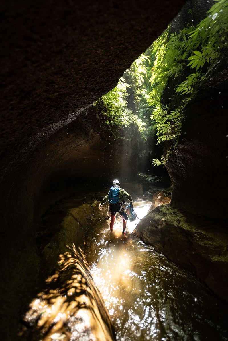 The wet season provides exciting water levels but some canyons might not be accessible; it also requires careful planning due to the daily tropical downpours which often result in flash floods. Here, Re:belay Editor Gus Schiavon during the first descent of Tukad Marah, Sekumpul.