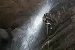 Iranian Canyoneer Tina Andayesh rappelling down a waterfall