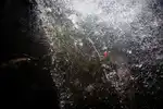 Rappeling under a waterfall